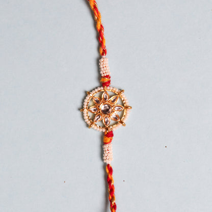 Rakhi bracelet from India featuring pearls and a special stone in wheel design