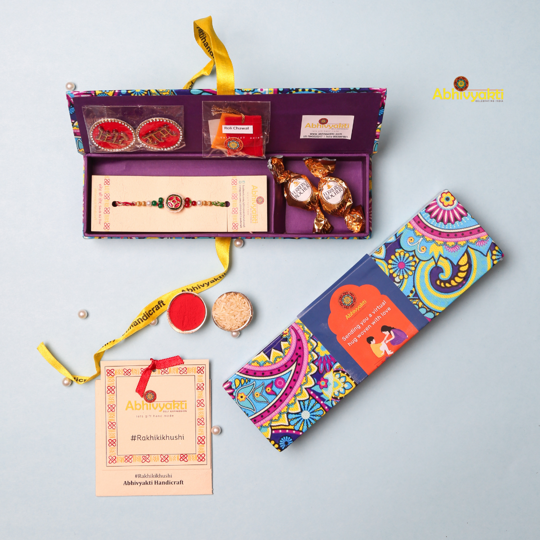 A beaded red and gold-plated rakhi against a light blue background. A colorful stone rakhi with a gold and blue threads, packed in a beautiful hamper premium quality box