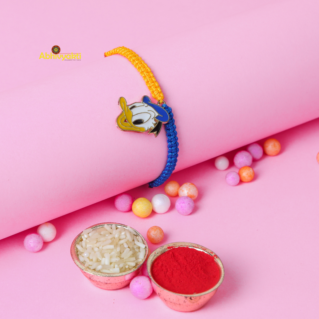 Rakhi designed for kids, showcasing a charming Donald Duck pin on the bracelet with roli chawal