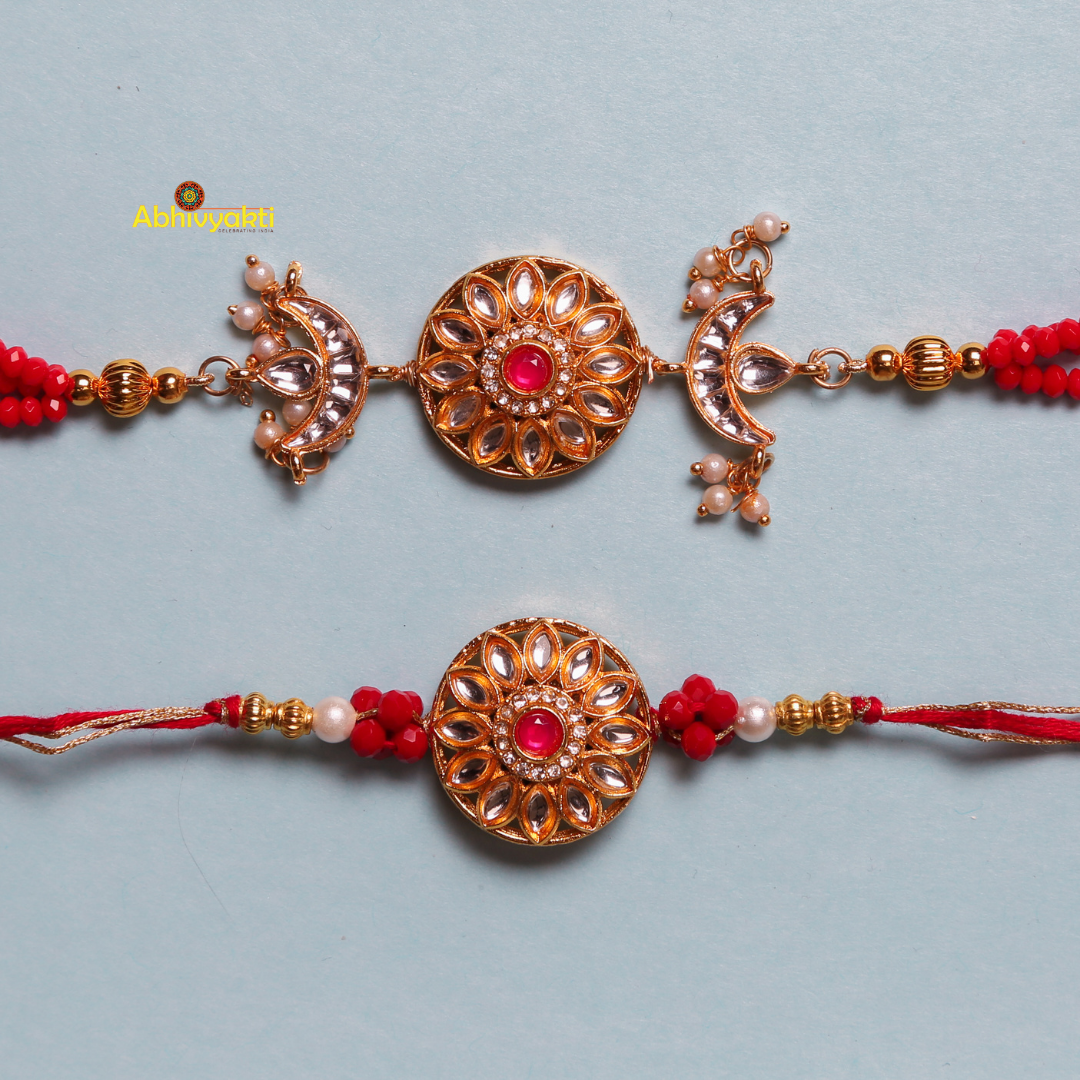 Two red and gold rakhi with red beads, featuring a unique design with stones and beads.