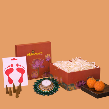 A festive Diwali hamper filled with an assortment of decorative items and treats. The hamper includes colorful floating diya, a box of mithai sweet candle and fragrant incense sticks. The items are beautifully arranged in a festive box with vibrant, rich colors and intricate detailing, evoking the spirit of Diwali celebrations. The hamper is a perfect gift for the festive vibe