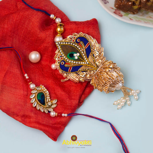Peacock and pearl necklace on red cloth, with Rakhi lumba rakhi featuring stones & beads.