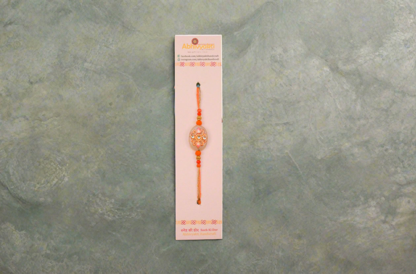 orange stone kundan rakhi. 