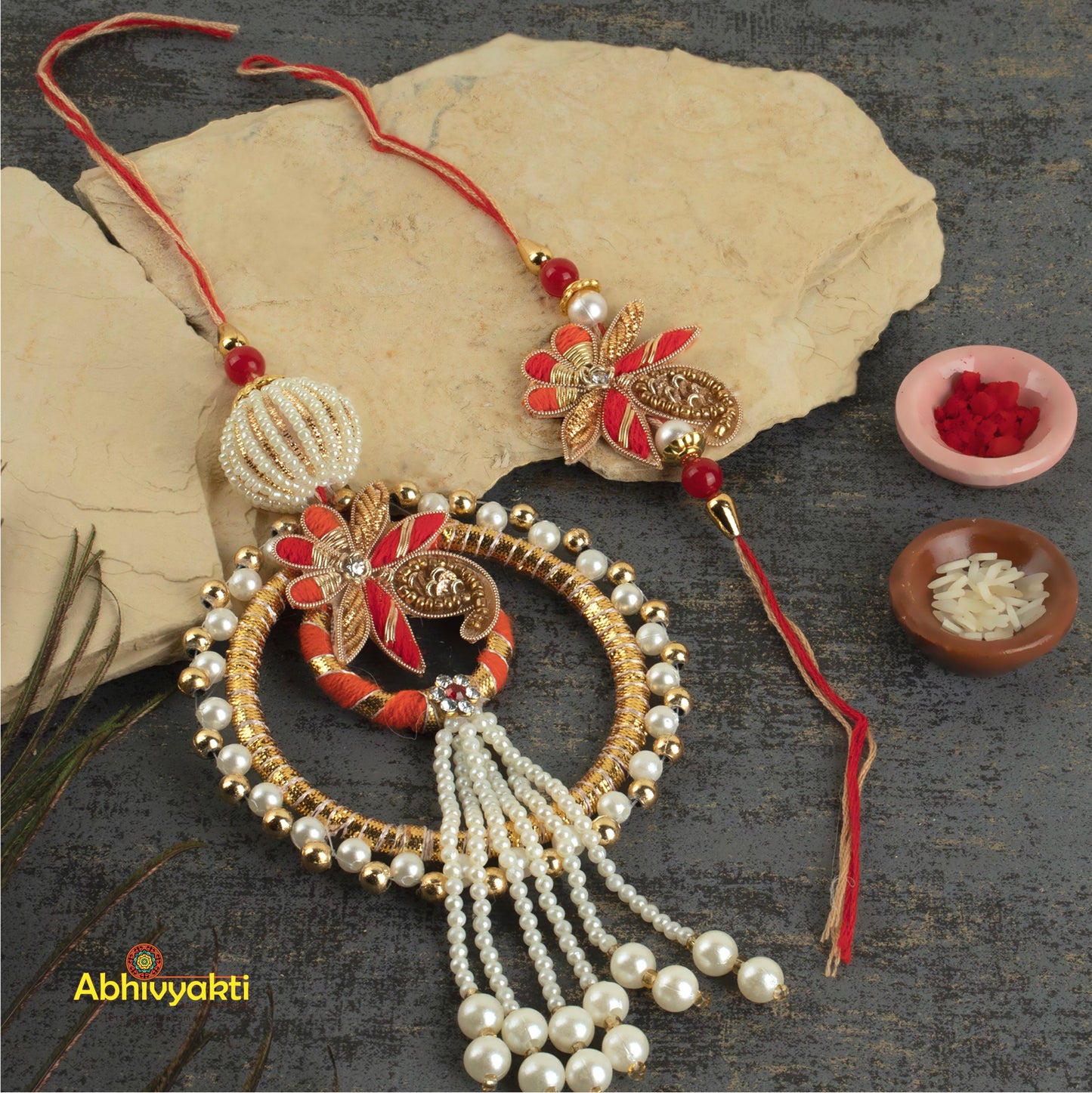 Elegant red and white rakhi featuring pearls and beads, a decorative lumba rakhi with stones & beads.