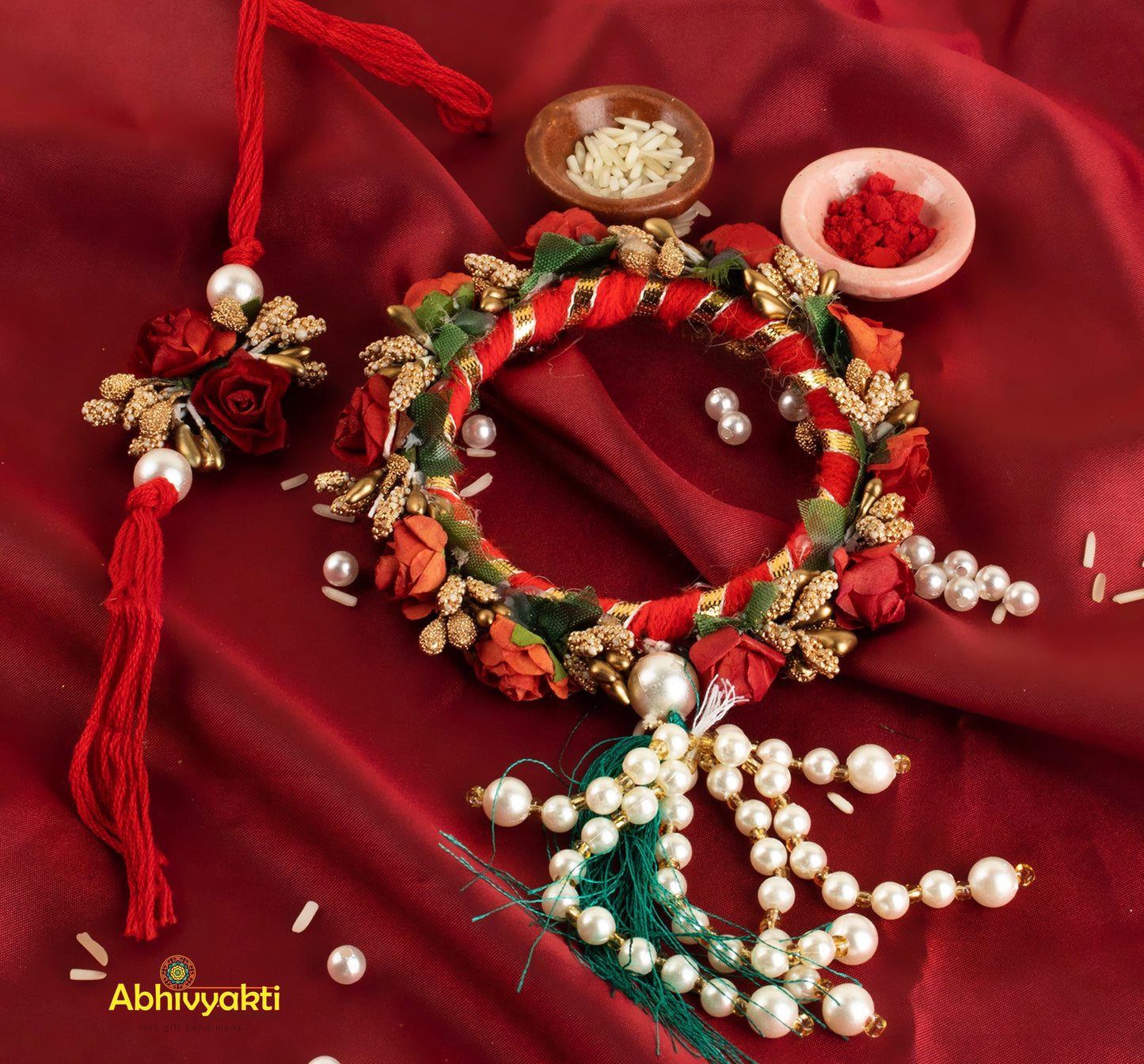 Red and white floral Rakhi lumba wreath adorned with pearls and beads.