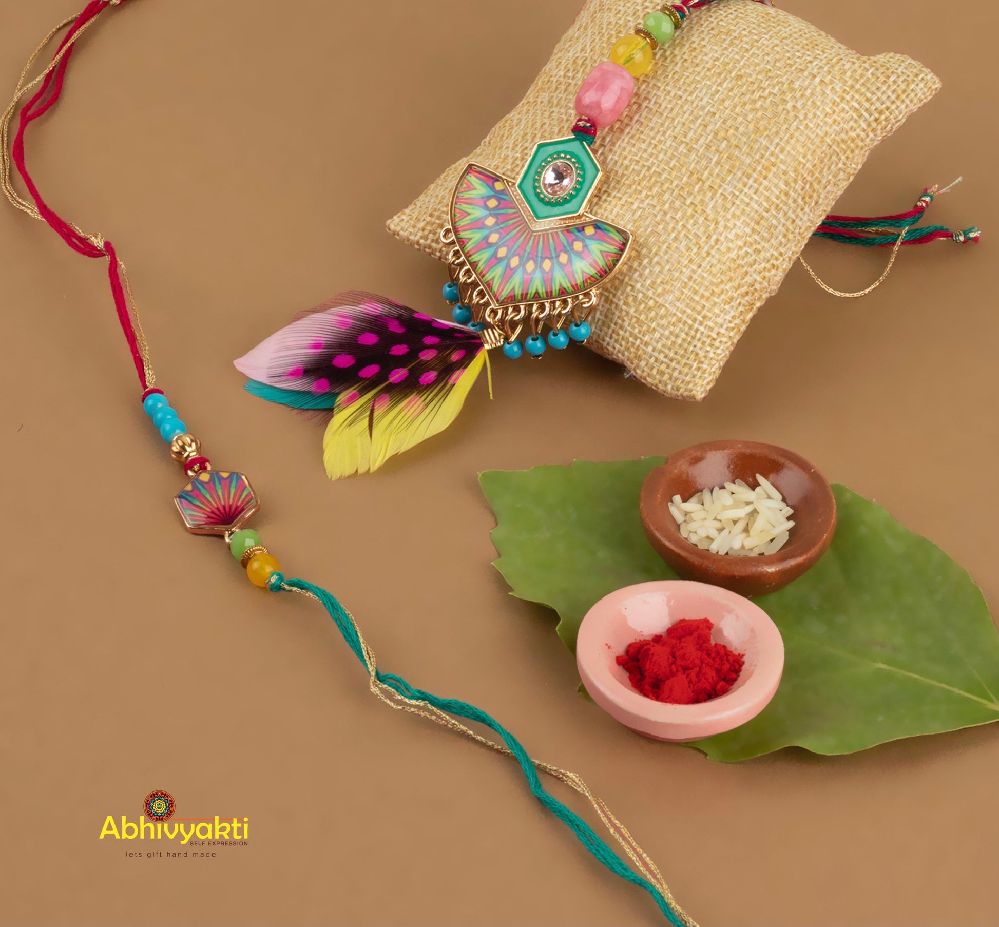 Multicolor Rakhi lumba adorned with feather, stones, and beads.