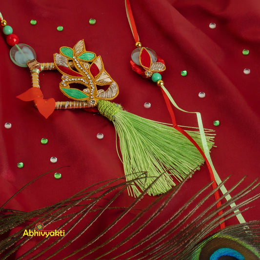 Colorful peacock feather and red/green Rakhi lumba necklace adorned with stones and beads.