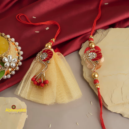 Elegant rakhi lumbas with intricate gold and red beadwork, accented by beautiful beads and stones.