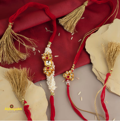 Rakhi lumba featuring red and gold tassels, beautiful beads, stones, and a unique design.