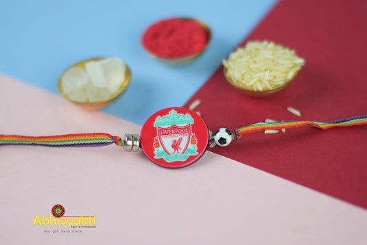 Liverpool football badge with red ribbon and rice, beautiful kids rakhi with beads.