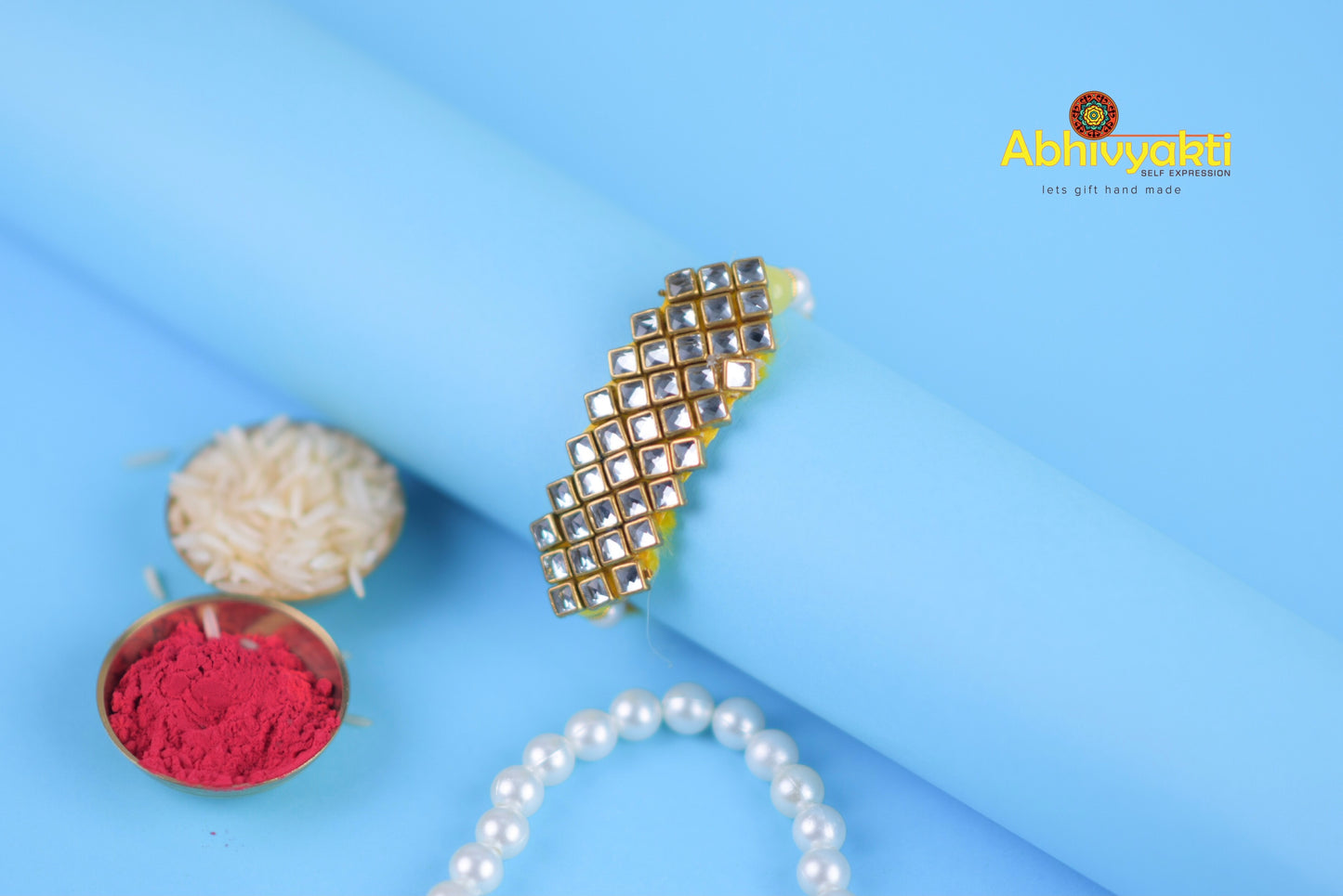 Stylish gold bracelet featuring pearls, red powder, stones, and beads.