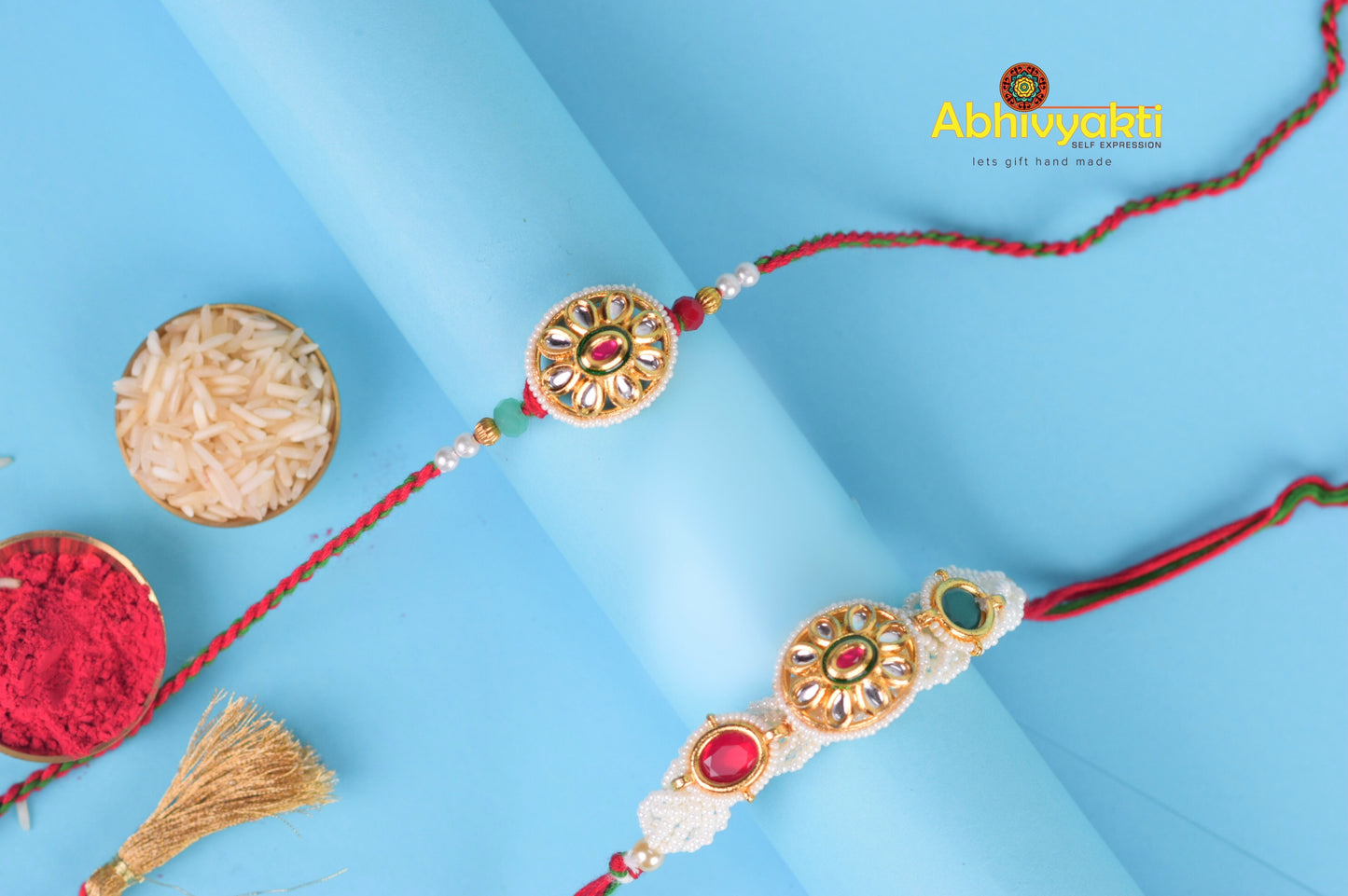 Two rakhi's with gold and red beads, rakhi lumba design with beautiful beads and stones.