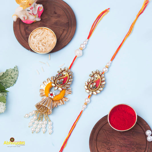 Exquisite rakhi lumba rakhi with pearls, gold thread, and beads.