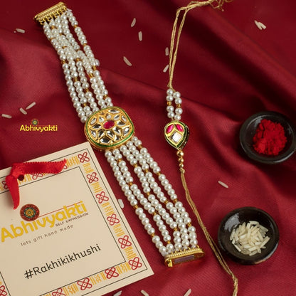 Exquisite bracelet embellished with gold and pearl beads, highlighting a gorgeous rakhi lumba with stones and beads.