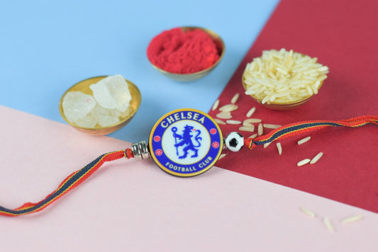 A kids Rakhi with beautiful beads and a Chelsea badge, surrounded by roli and rice.